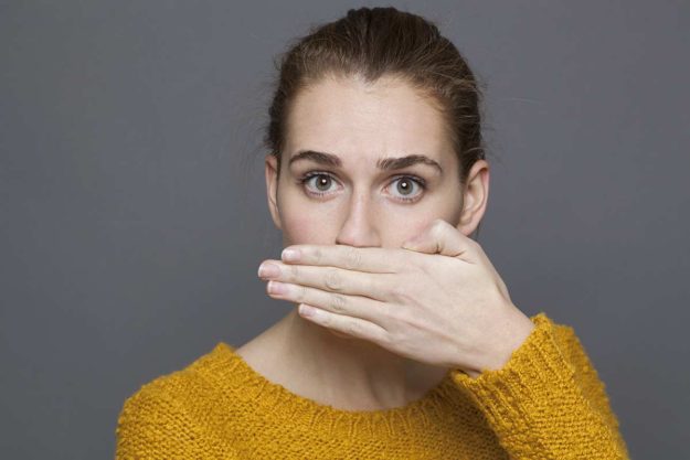 bad breath a woman is embarrassed by her bad breath