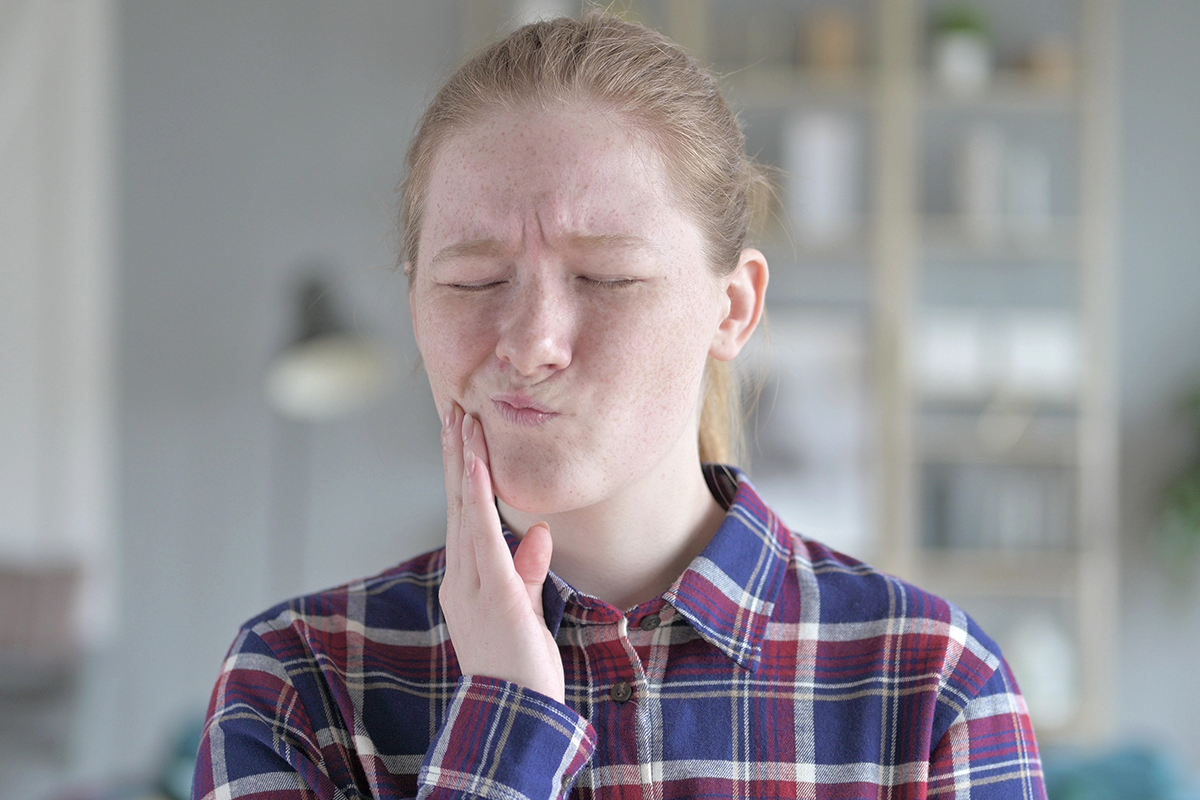 a woman struggling with common dental problems