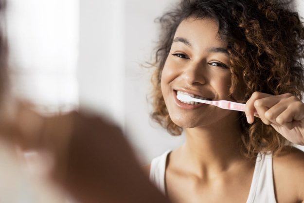 oral care woman brushes teeth after Halloween