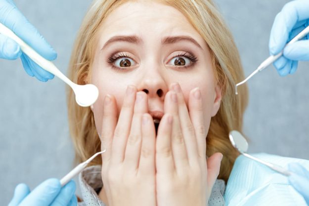 scared of the dentist Woman is scared of dentist.