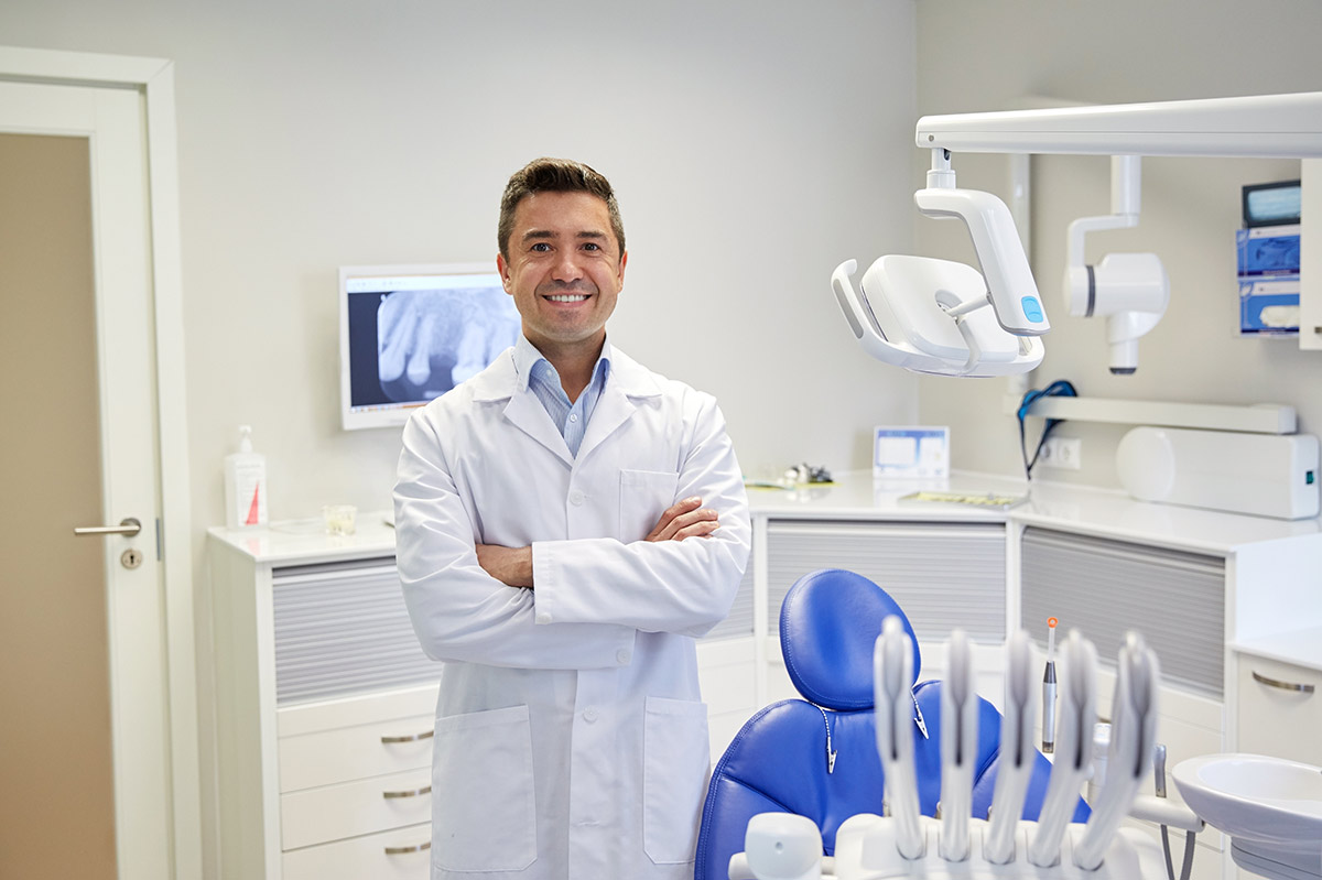 Dentists Dr. stands in his dental practice