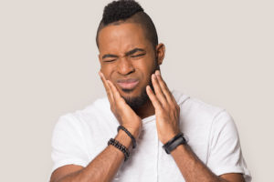 Man struggles with the effects of impacted teeth