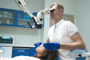 doctor performs a root canal on a patient 