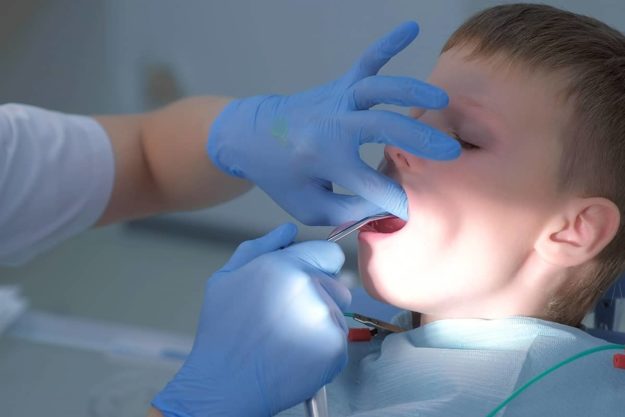 fluoride boy getting a fluoride treatment