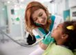 a woman works at a pediatric dental office