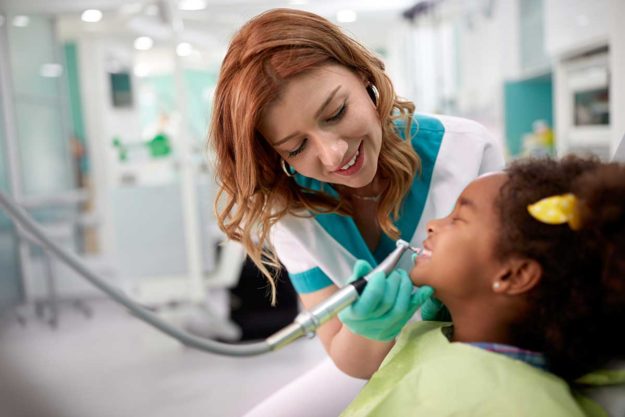 How-to-Choose-a-Pediatric-Dental-Office a woman works at a pediatric dental office